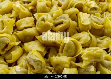 Traditional Italian Raw Tortellini Background. Italian Fresh Pasta. Stock Photo