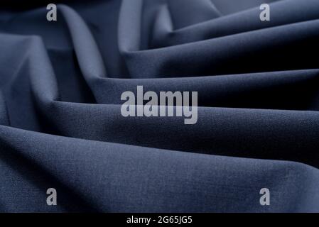 Cloth. Background of a crumpled piece of gray fabric in close-up. Material for sewing clothes. Work for a tailor, fashion designer and seamstress Stock Photo