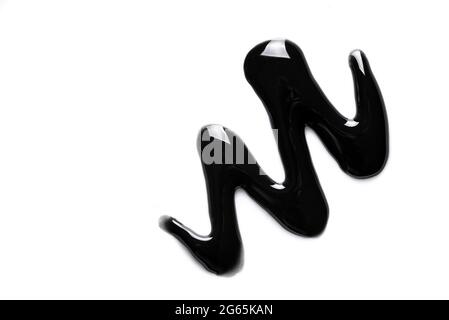 Black cosmetic gel sample isolated on white background. Black charcoal mask texture close up. Stock Photo
