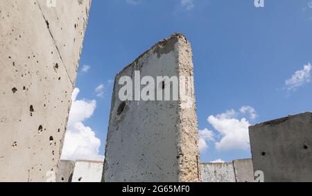 Old concrete slabs standing on a summer sunny day in the field. Old unfinished building Stock Photo