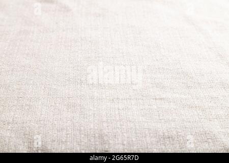 Fragment of smooth white linen tissue. Side view, natural textile background and texture. Stock Photo