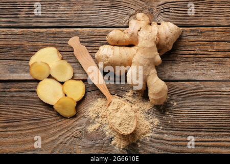 Spoon with ginger powder on wooden table Stock Photo