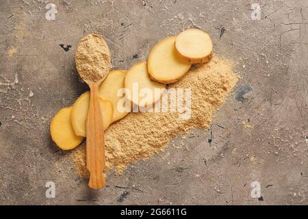 Spoon with ginger powder on grunge background Stock Photo