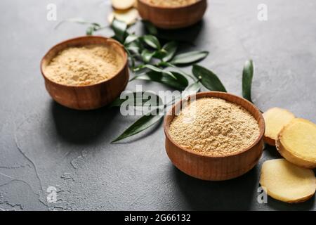 Bowls with ginger powder on dark background Stock Photo