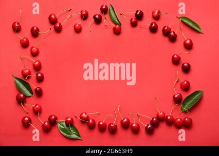 Frame made of tasty ripe cherry on color background Stock Photo