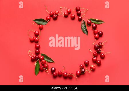 Frame made of tasty ripe cherry on color background Stock Photo