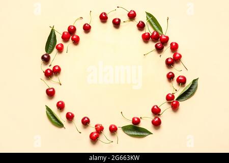 Frame made of tasty ripe cherry on color background Stock Photo