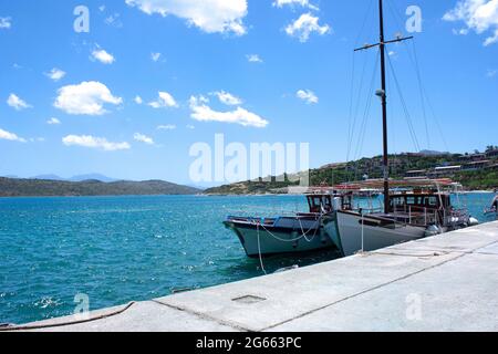 A small fishing boat moored to the quay in Crete Stock Photo