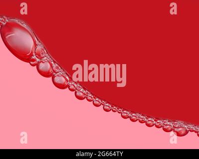 bubble chain on surface in red soft drink, close up, abstract red background of bubbles Stock Photo