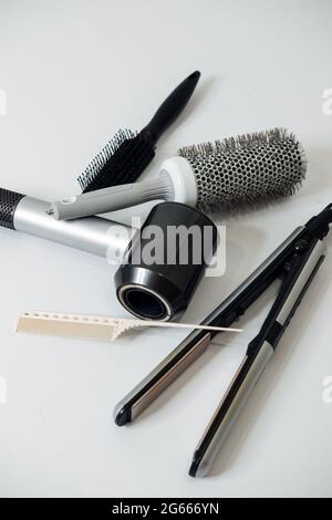 Hairdressing Tools and Equipment. Hair dryer, Paddle Brush, variety of combs, Water Bottle, Round Brush, texture iron or mini crimping iron Stock Photo
