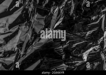 Wrinkled black shiny abstract background Stock Photo