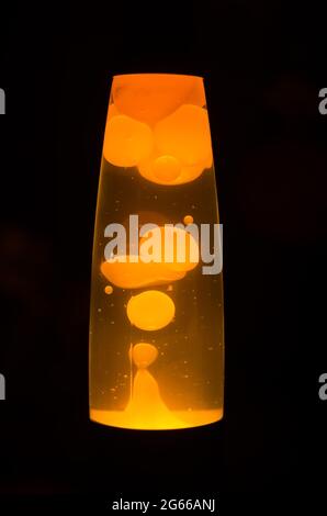 Orange lava lamp bubbles on a black background Stock Photo