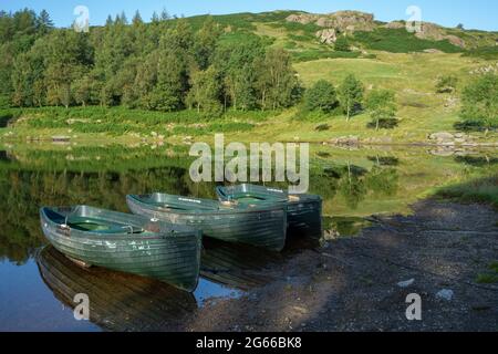 Rowing Boats Moored at Watendlath Tarn in the Lake District Cumbria Stock Photo