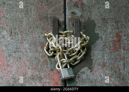 Vintage, grunge, door secured by padlock and chain Stock Photo