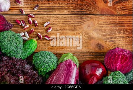 Different fresh vegetables on wooden background. Flat lay, mockup. Top view Stock Photo