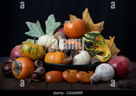 Top of basket with assorted fruit and vegetables against white background, side view, and decorated with sunflowers, summer harvest concept, Californi Stock Photo