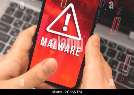 Data breach and malware, cyber attack and hacking concept, woman using mobile phone with warning sign Stock Photo