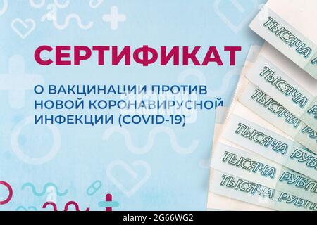 Moscow, Russia - July 3, 2021. Russian money lying on the certificate of COVID-19 vaccination. Concept of an illegal purchase of the russian certifica Stock Photo