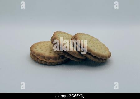 Group shoot of stacked biscuits isolated white background Stock Photo