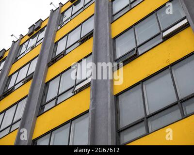 Geometric facade of building in the colors 2021. Yellow and gray wall. Year color concept Stock Photo
