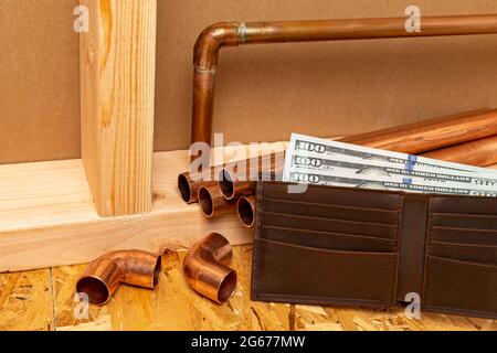 Copper plumbing pipe and money in wallet. Construction, repair and home maintenance cost concept Stock Photo