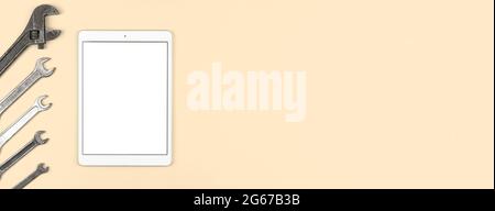 Service equipment and temaplet with tablet blank white screen on the table, beige background, top view, flat lay and copy space Stock Photo