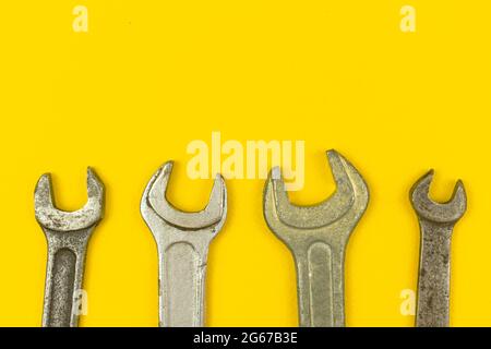 Wrench tools worker border composition with yellow office table background, flat lay and top view with copy space Stock Photo