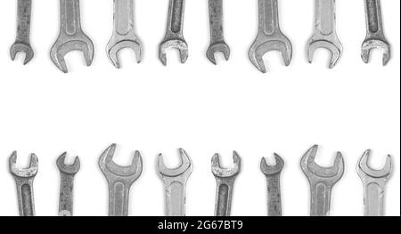 Assorted wrenches border, repair tools on white background, top view and copy space Stock Photo