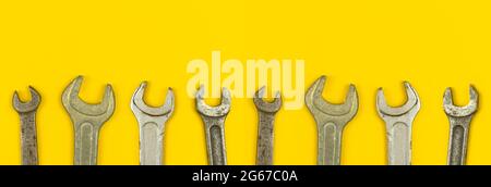 Wrench tools wide web banner, repair tool and contruction equipment concept background, yellow office table top view and flat lay