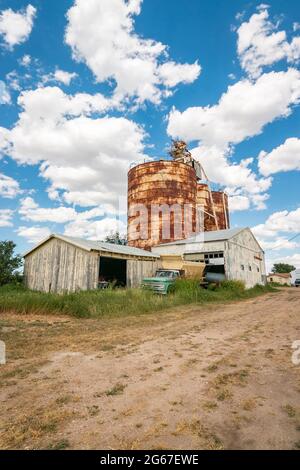 storage tanks grain silos and vintage farm pickup on Route 66 Texas Stock Photo