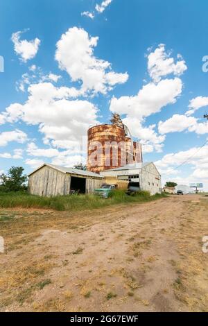 storage tanks grain silos and vintage farm pickup on Route 66 Texas Stock Photo