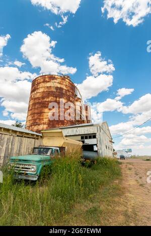 storage tanks grain silos and vintage farm pickup on Route 66 Texas Stock Photo