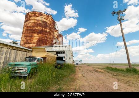 storage tanks grain silos and vintage farm pickup on Route 66 Texas Stock Photo