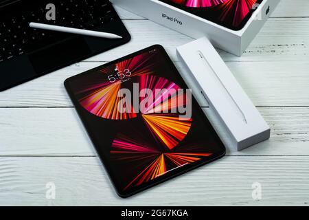 iPad Pro 11-inch 2021 model with Apple M1 chip on a desk with Magic keyboard and Apple pencil Stock Photo