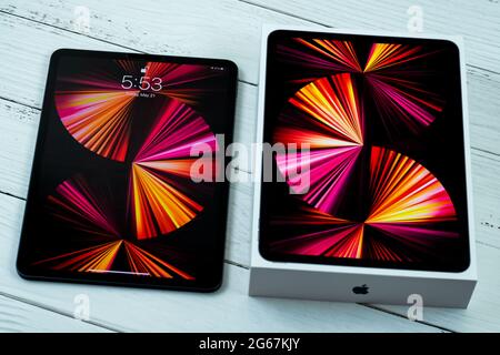 iPad Pro 11-inch 2021 model with Apple M1 chip on a desk with Magic keyboard and Apple pencil. Stock Photo