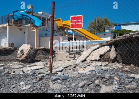 The territory of the water park destroyed by water flows after bad weather. Consequences of heavy rains. Dangerous zone, no passage - transfer. Stock Photo