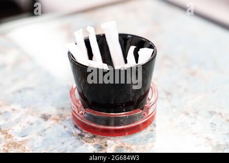 Packaging Sachet Of Sugar Stick Standing On Table Stock Photo