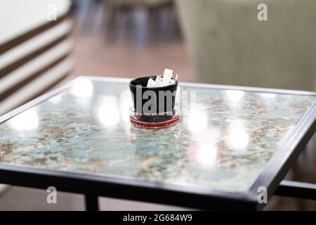 Packaging Sachet Of Sugar Stick Standing On Table Stock Photo