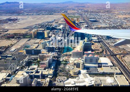 A Boeing 780 Max airplane wingtip in the foreground of aerial view of the Vegas strip after liftoff from Las Vegas McCarran International Airport, NV Stock Photo