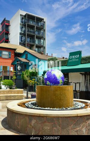 The landmark blue mosaic globe water fountain at Piazza Basilone in Little Italy, surrounded by restaurants, shops and condos in San Diego, CA, USA Stock Photo