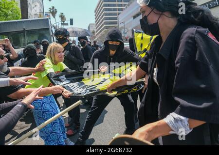Los Angeles, CA, USA. 3rd Jul 2021. Protesters clash during a protest on Saturday against a Koreatown Spa called Wi Spa. The initial protest , which had been planned against the spa's policy regarding transgender customers, was met with a pro-transgender counter protest. Credit: Young G. Kim/Alamy Live News Stock Photo