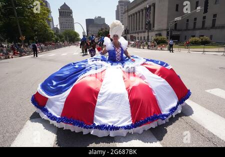 St. Louis, United States. 03rd July, 2021. A woman with a large Red, white and blue dress makes her way down the street America's Birthday Party Parade in downtown St. Louis on Saturday, July 3, 2021. Photo by Bill Greenblatt/UPI Credit: UPI/Alamy Live News Stock Photo