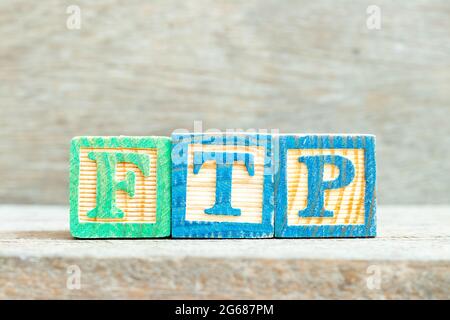 Color alphabet letter block in word FTP (Abbreviation of File Transfer Protocol) on wood background Stock Photo