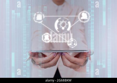 Lady In Uniform Touching Different Application In Projected Hologram. Business Woman In Suit Holding Phone Displaying And Using Futuristic Holographic Stock Photo