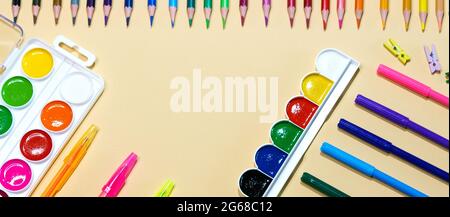 Colored pencils and markers with pens and paint on paper background with copy space. Childrens creativity, back to school concept Stock Photo