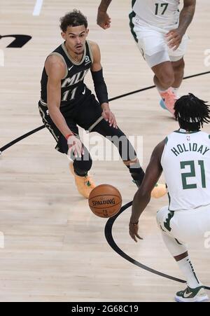 Atlanta, USA. 04th July, 2021. The Atlanta Hawks' Trae Young (11) works against the Milwaukee Bucks' Jrue Holiday (21) in Game 6 of the Eastern Conference Finals on Saturday, July 3, 2021, at State Farm Arena in Atlanta. The Bucks advanced, 118-107. (Photo by Curtis Compton/Atlanta Journal-Constitution/TNS/Sipa USA) Credit: Sipa USA/Alamy Live News Stock Photo
