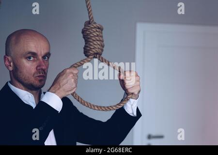 Businessman commits suicide by hanging. Suicide. Stock Photo