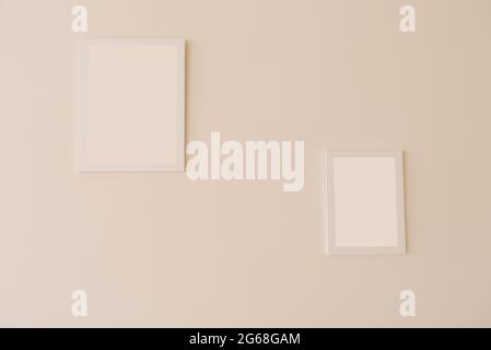 White mockup frames on a beige wall of different sizes Stock Photo