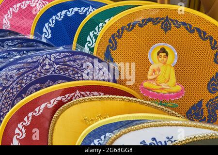 Ritual fans (talapat) with an image of the Buddha, used by Buddhist monks; at a shop for Buddhist ritual objects, Bamrung Muang Rd., Bangkok, Thailand Stock Photo