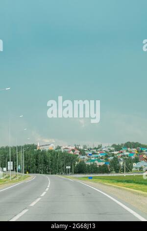 road near the village. gray clouds across the sky. empty road Stock Photo